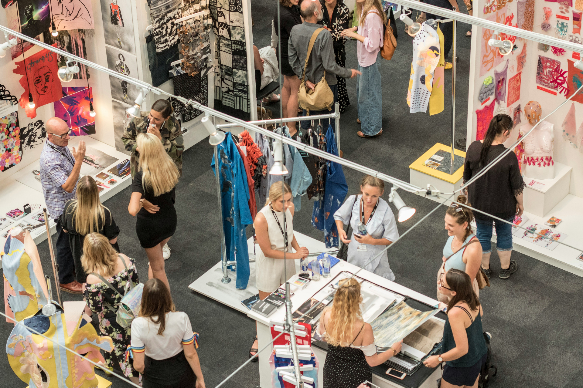 Exhibition hall visitors exploring booths