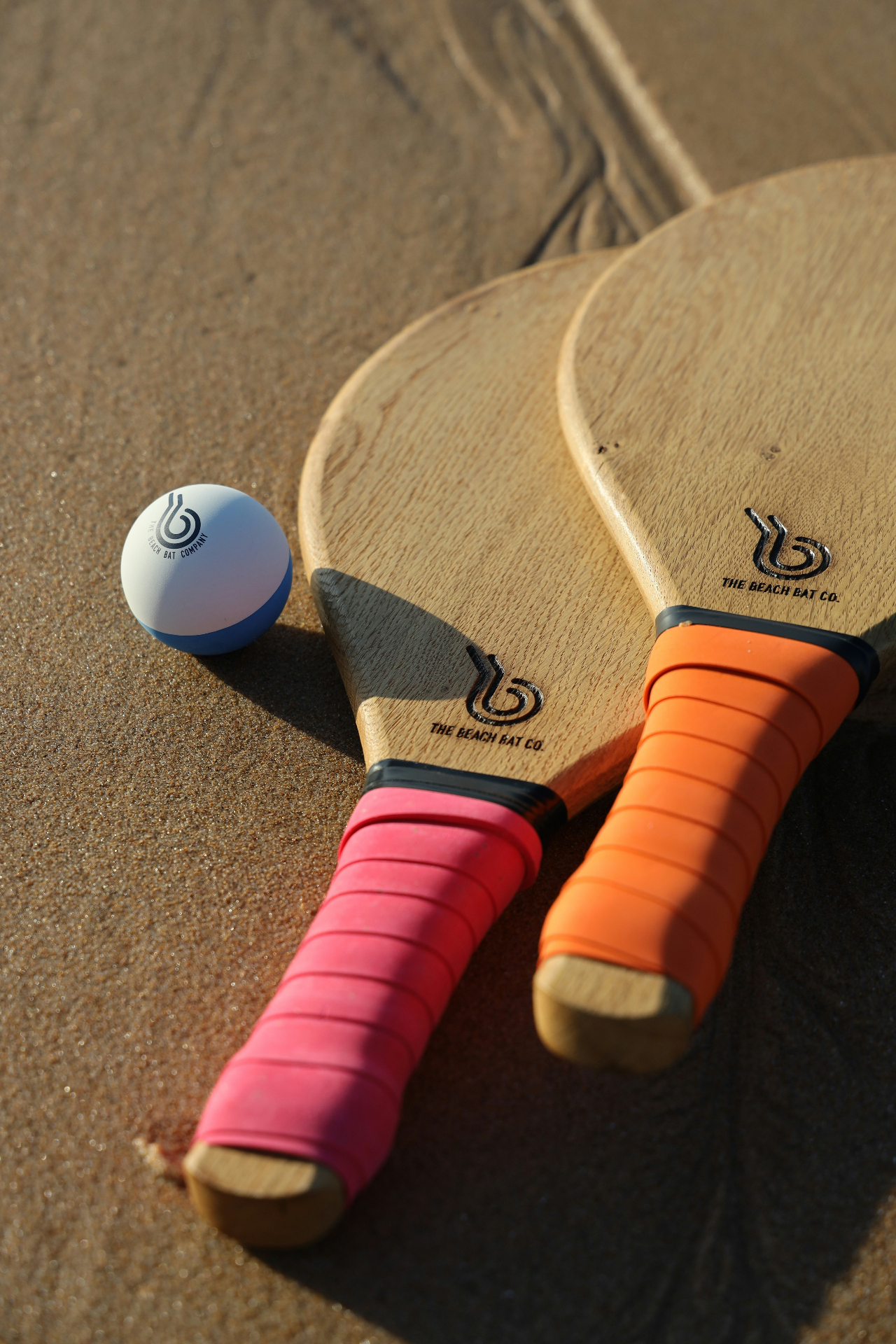 Beach bats and ball on golden sand