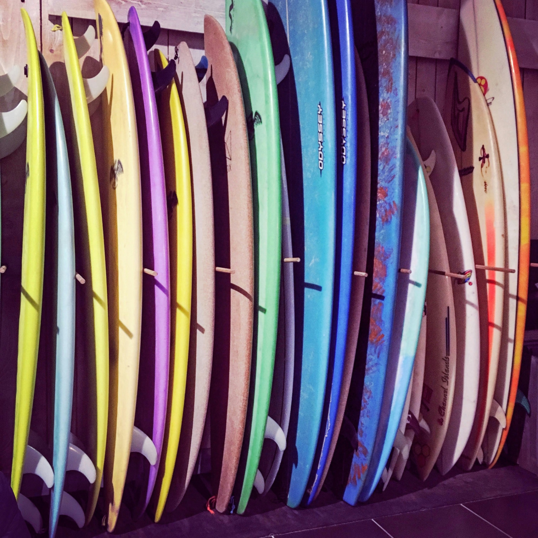 Colorful surfboards lined up in a rack